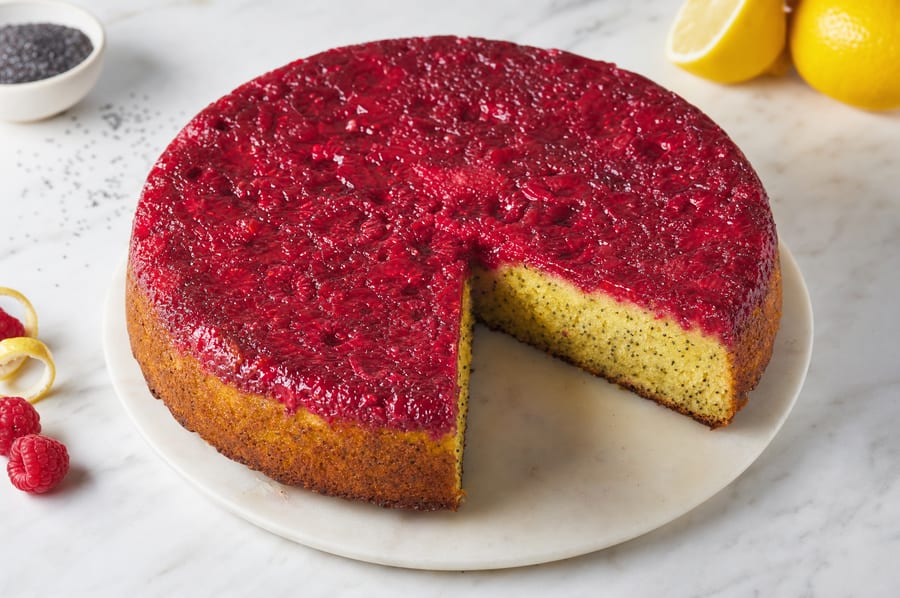 Slice of Upside-Down Raspberry, Lemon and Poppy Seed Cake