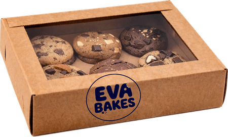 Open kraft gift box with six assorted Eva Bakes cookies, cut out on a transparent background